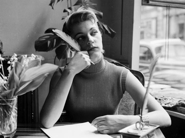 The only thing hotter than an attractive lady writing in her journal is an attractive lady writing in her journal while wearing a sleeveless mock turtleneck. (Via Planet Ivy)