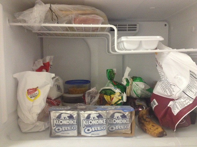 Still life with Klondike bars, banana, and frozen vegetables.