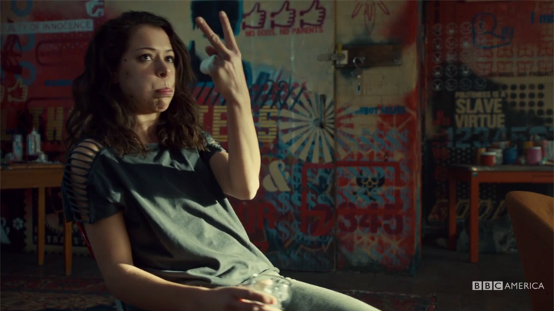 Sarah sticks her tongue out at Felix and flips him the backwards peace sign 