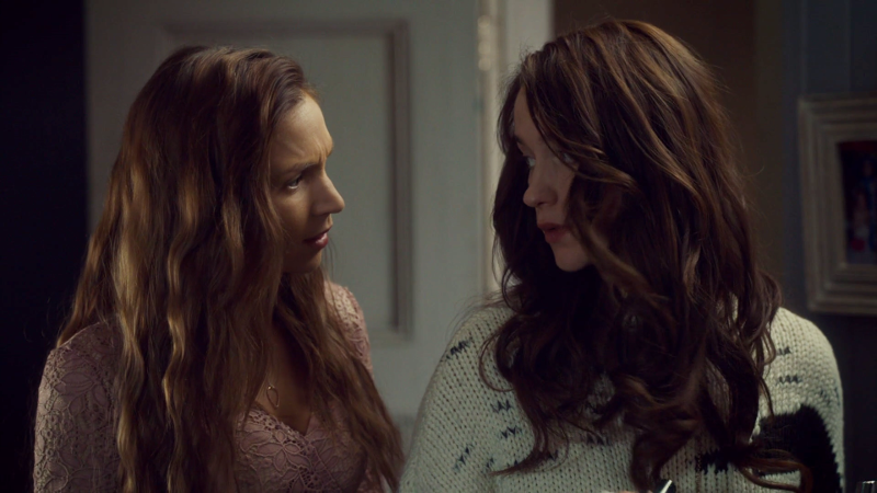 Wynonna and Waverly look at each other after doing a little sister bit