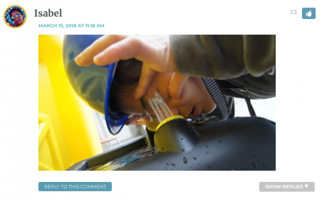 Photo of Isabel wearing a hard hat, washing her eyes out at a drinking fountain
