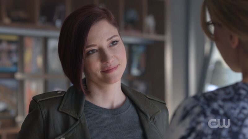 Alex smiles knowingly at her little sister
