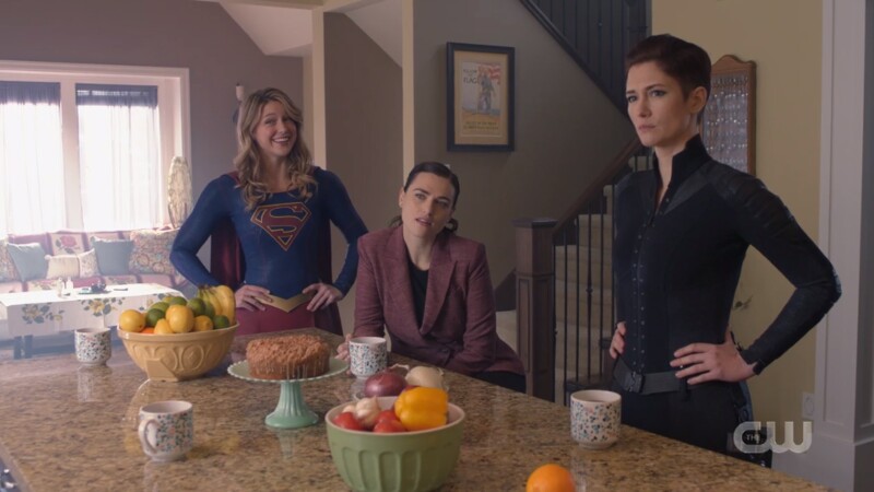 Supergirl looks cheerful, Lena looks untrusting, Alex looks stern