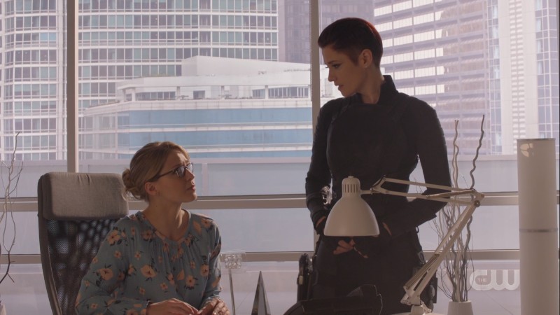 Alex and Kara look at each other in Lena's office