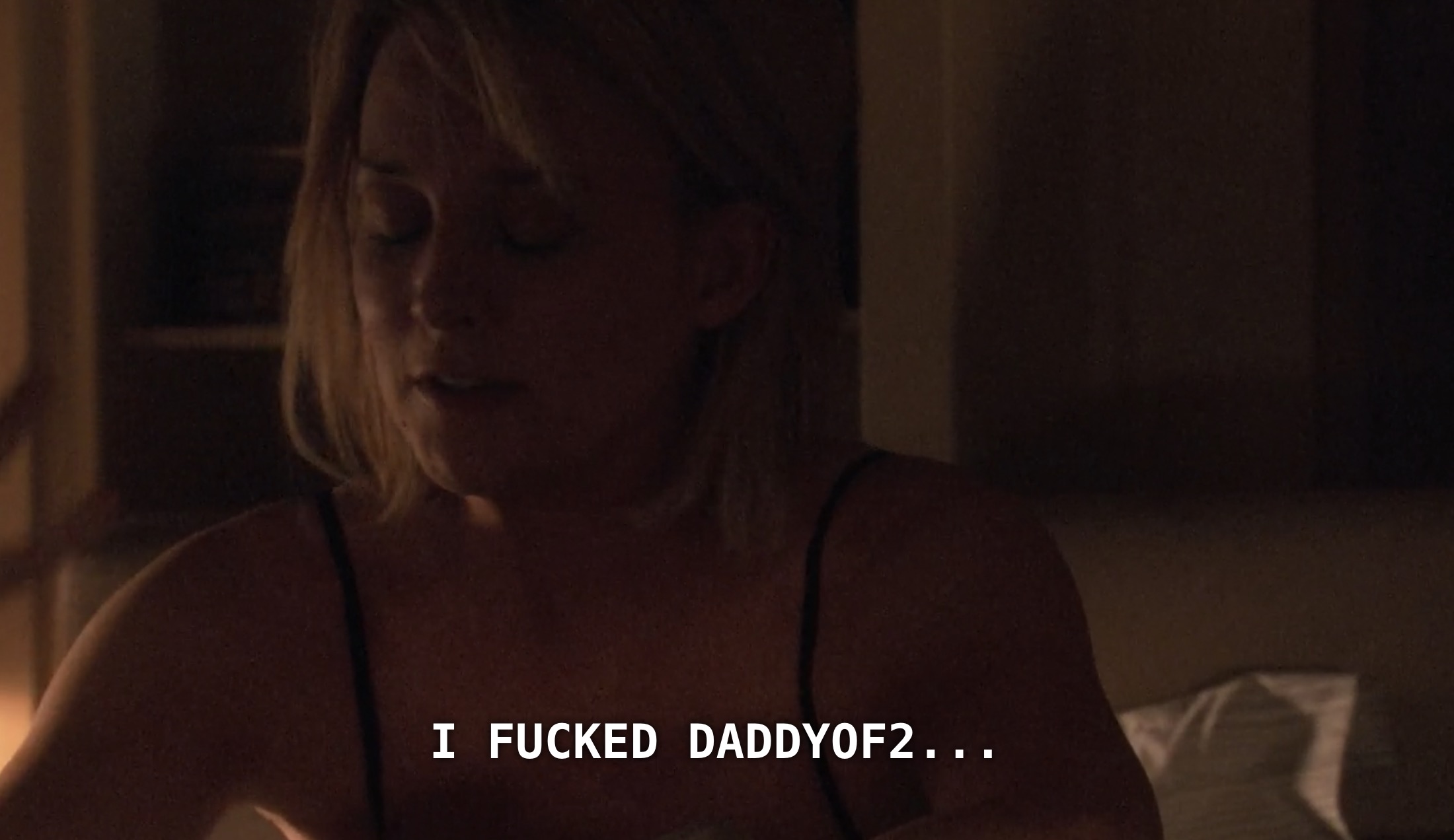 Tina is wearing a black tank top and is a dimly lit bedroom. She says, "I fucked DaddyOf2..."