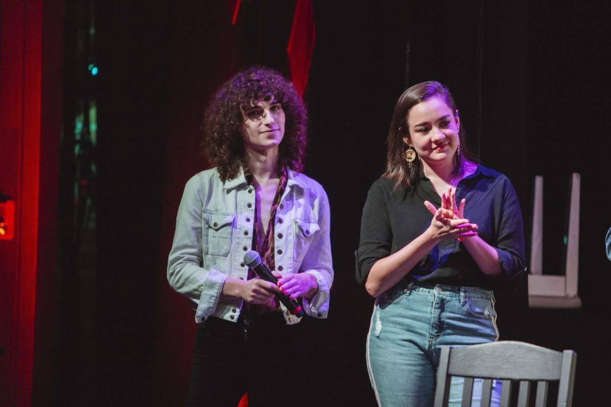Drew Gregory and Analyssa Lopez stand on stage.