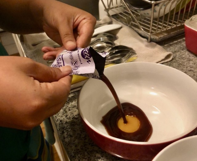 pouring sauce packet into bowl