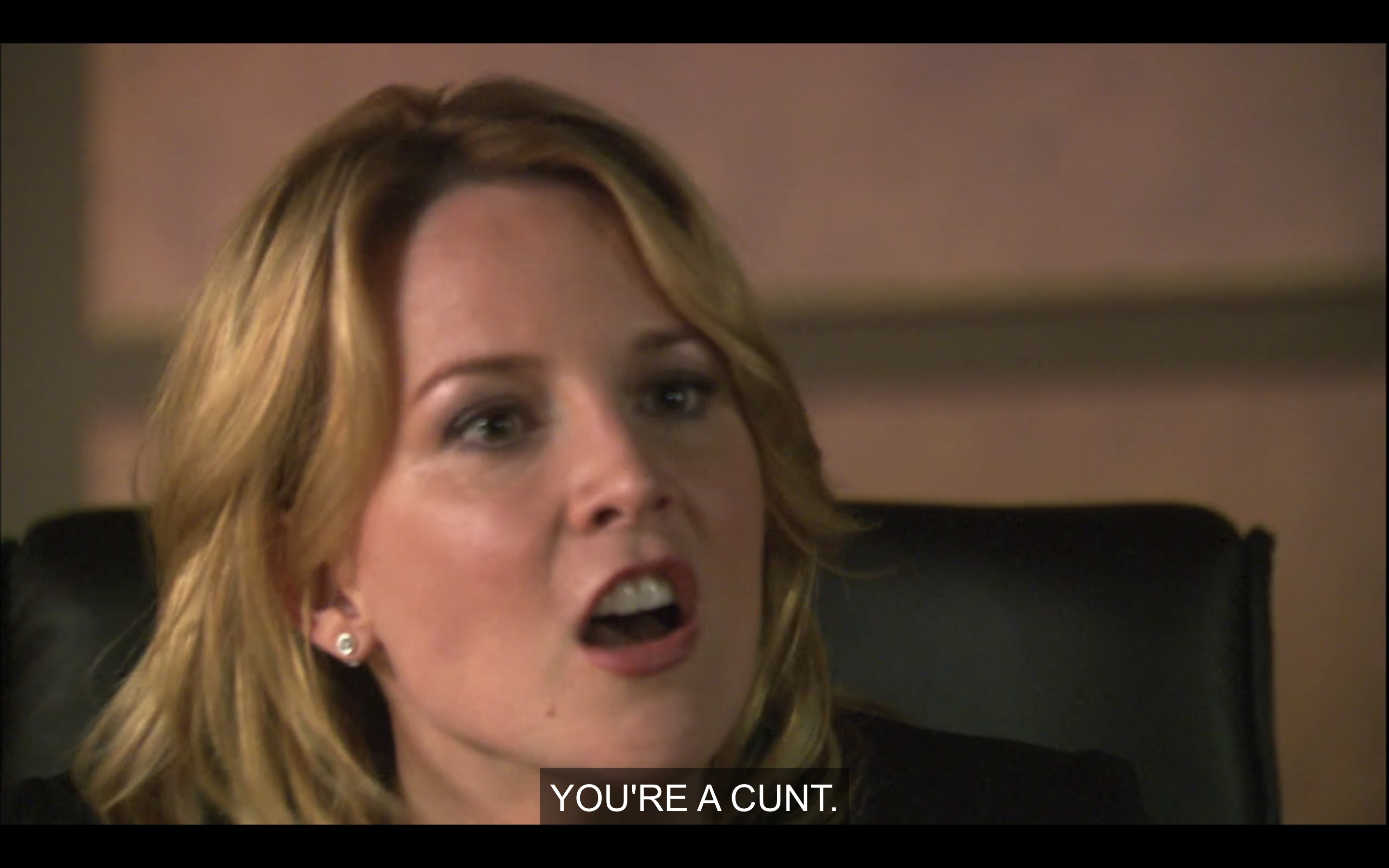 Close-up shot of Tina with her mouth open. She says, "You're a cunt."