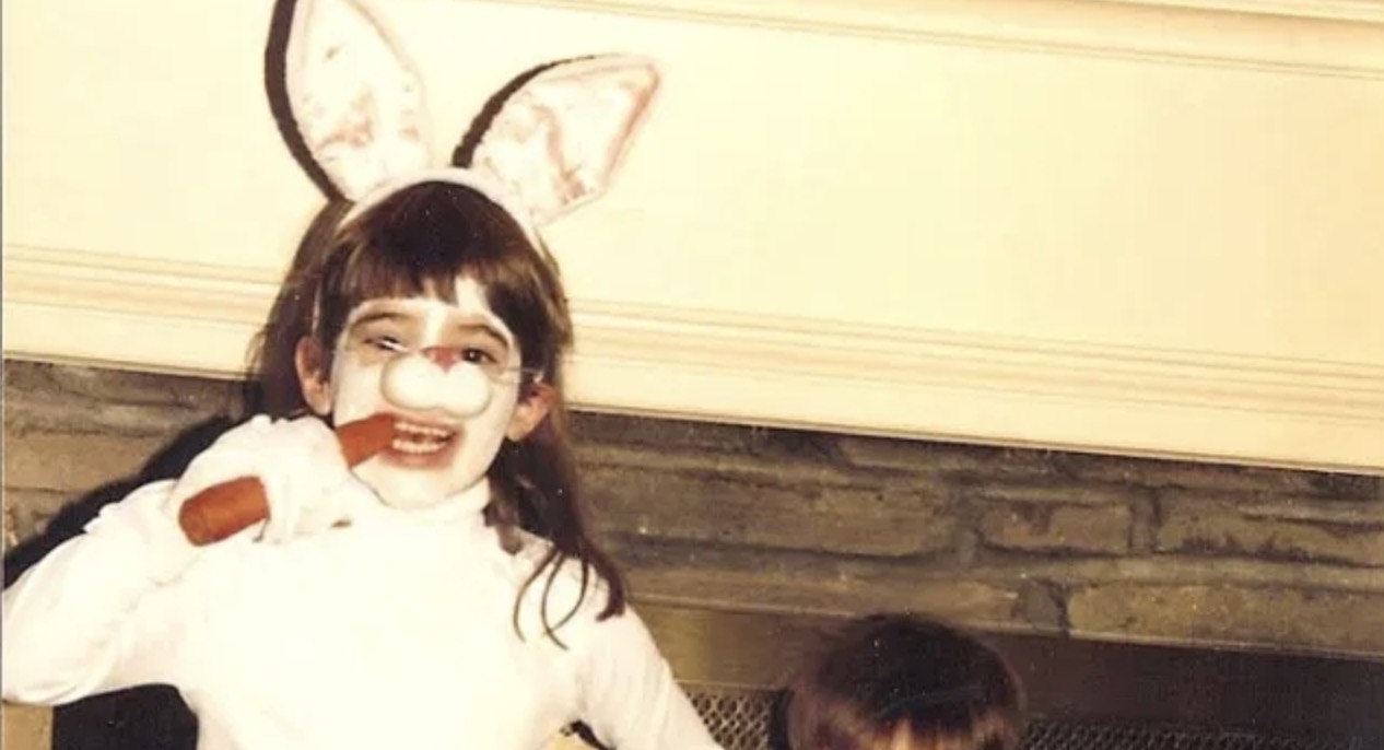 stef dressed up as a bunny for halloween eating a carrot many years ago