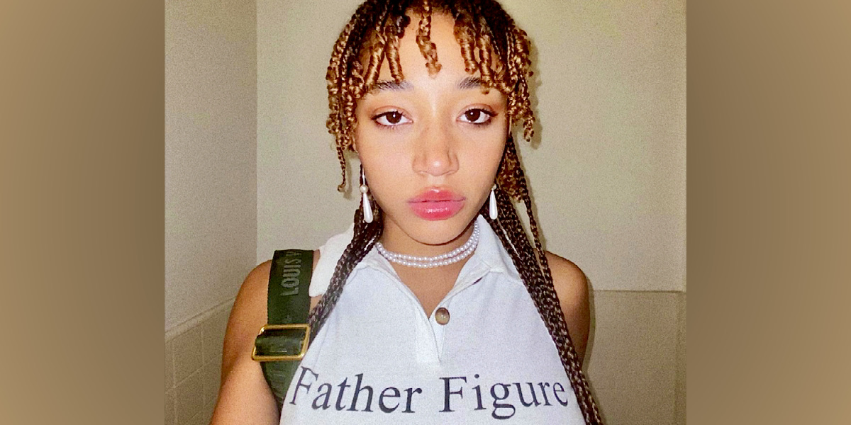 Actor Amandla Stenberg is in a white tank top that has 
