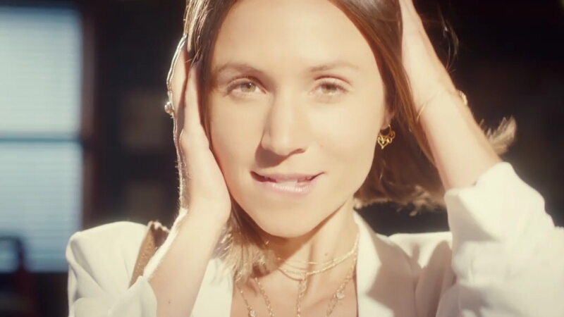 A soft light illuminates Waverly's face as she bites her lip and runs her hand through her hair looking directly to camera.