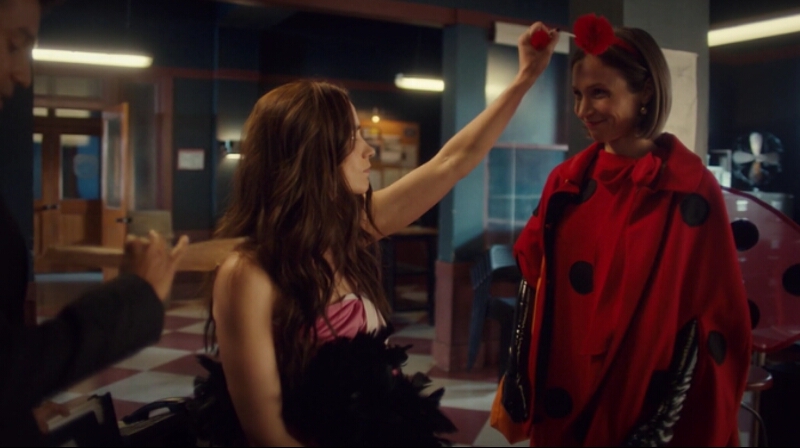 Wynonna Earp squeezes a ball on the ladybug antenna Waverly is wearing to top off her adorable Halloween costume.