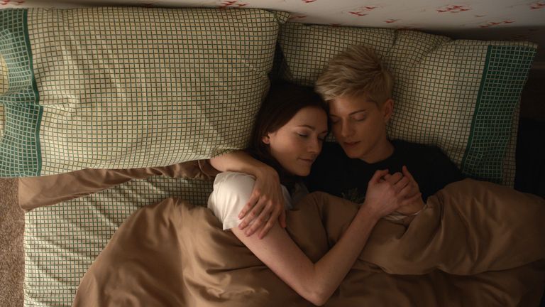 Mae and George cuddle in bed in Feel Good season two
