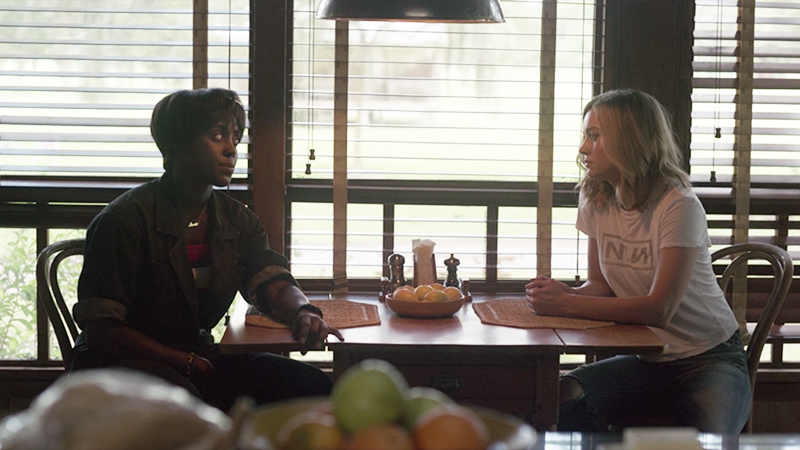 Carol and Maria sit at Maria's kitchen table.