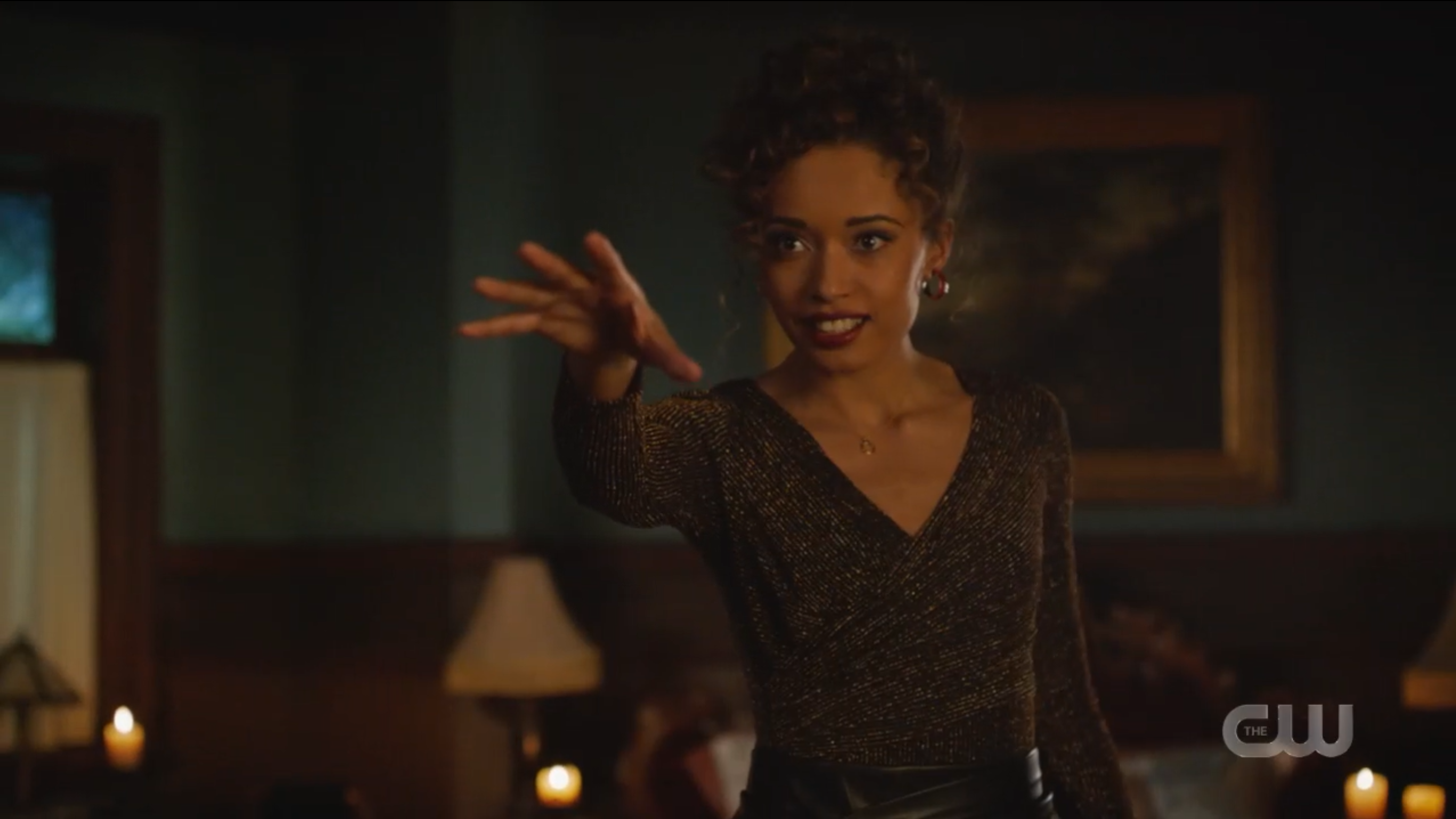 Astra waves her hand to do some magic. 
