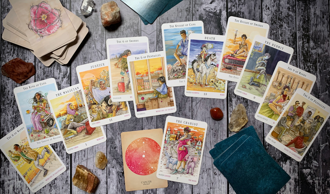 A spread of Next World tarot cards spread over a wooden backdrop