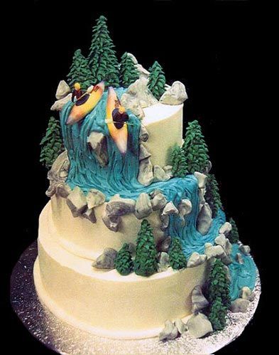 an incredible cake with a decoration of two kayakers paddling down a waterfall