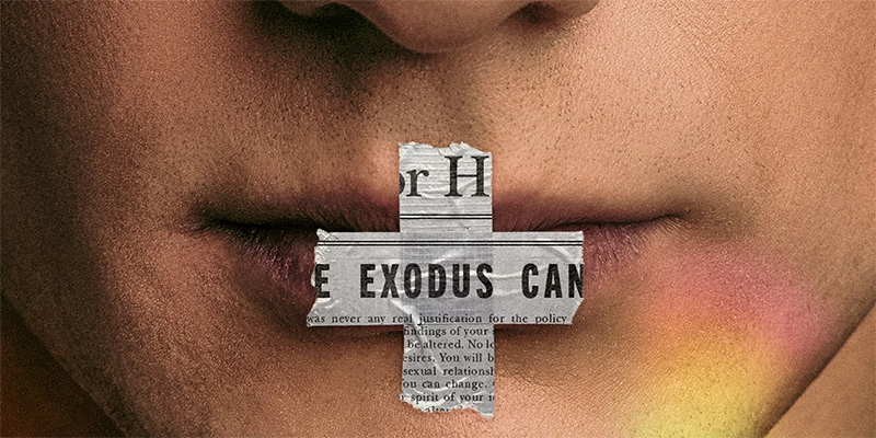 A close-up of a face with a cross made of newspaper over the lips. The cross says 