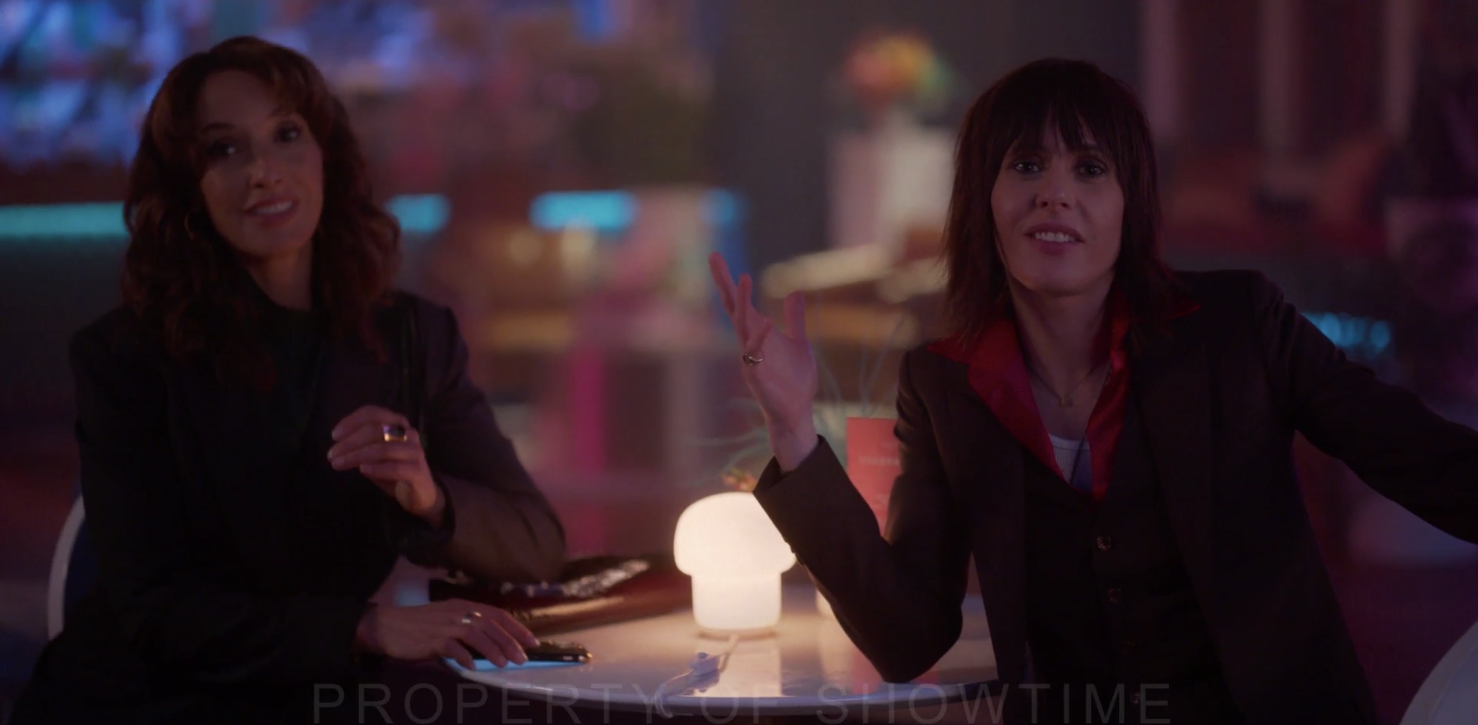 Bette and Shane at a table in a bar