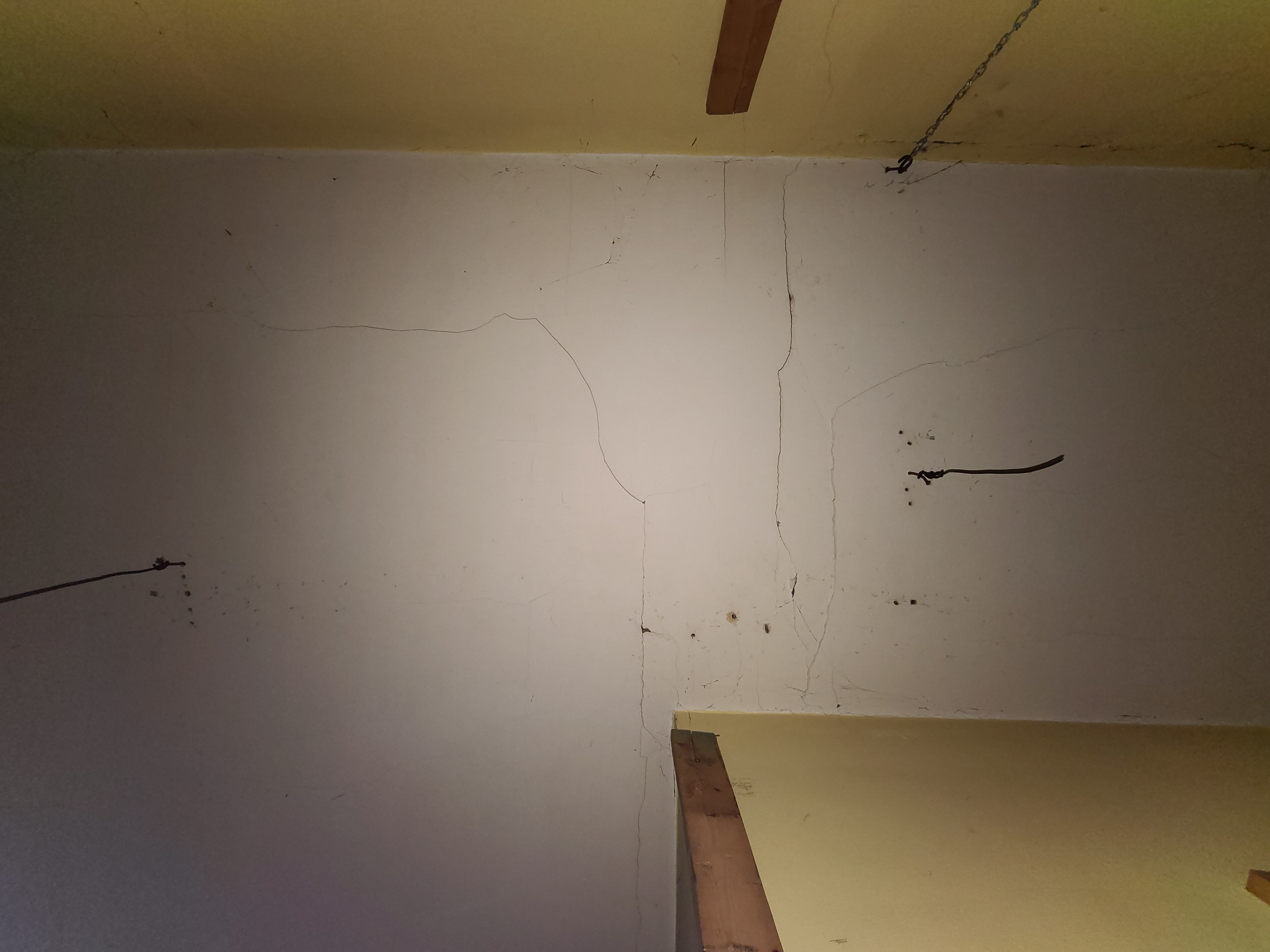 A photograph of the ceiling showing many uneven holes carelessly drilled by 'Dirk'