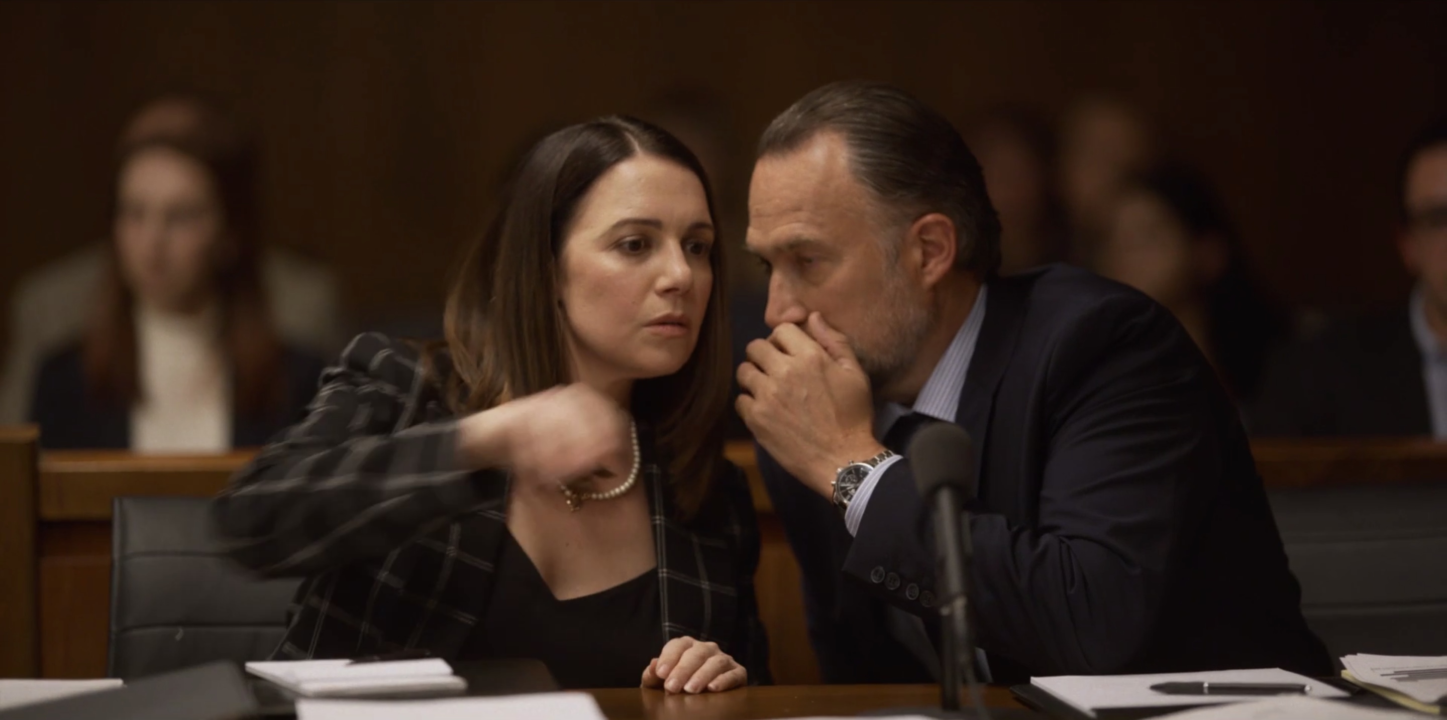 Rodolfo whispering into the ear of his lawyer