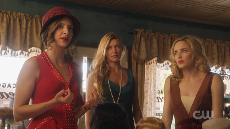 Zari, Ava and Sara look in disbelief at the racist cashier