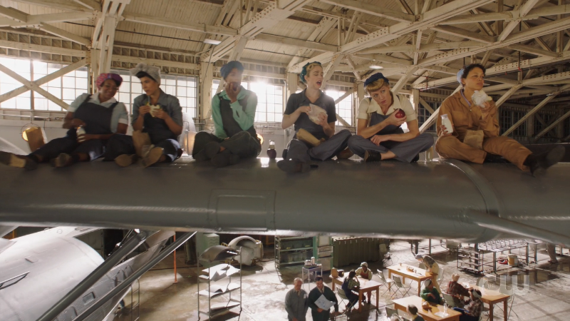 workers sit on the plane wing to eat