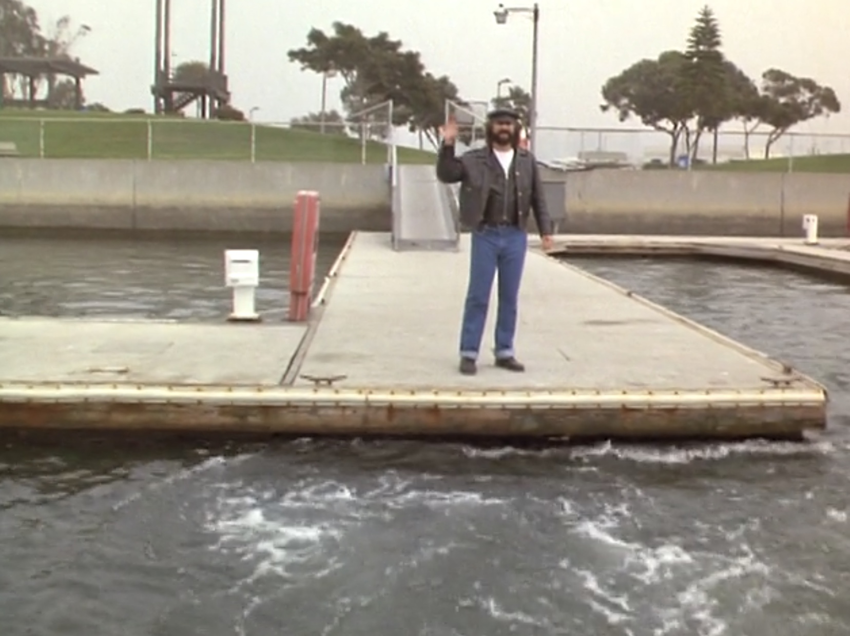 George waves goodbye from the dock
