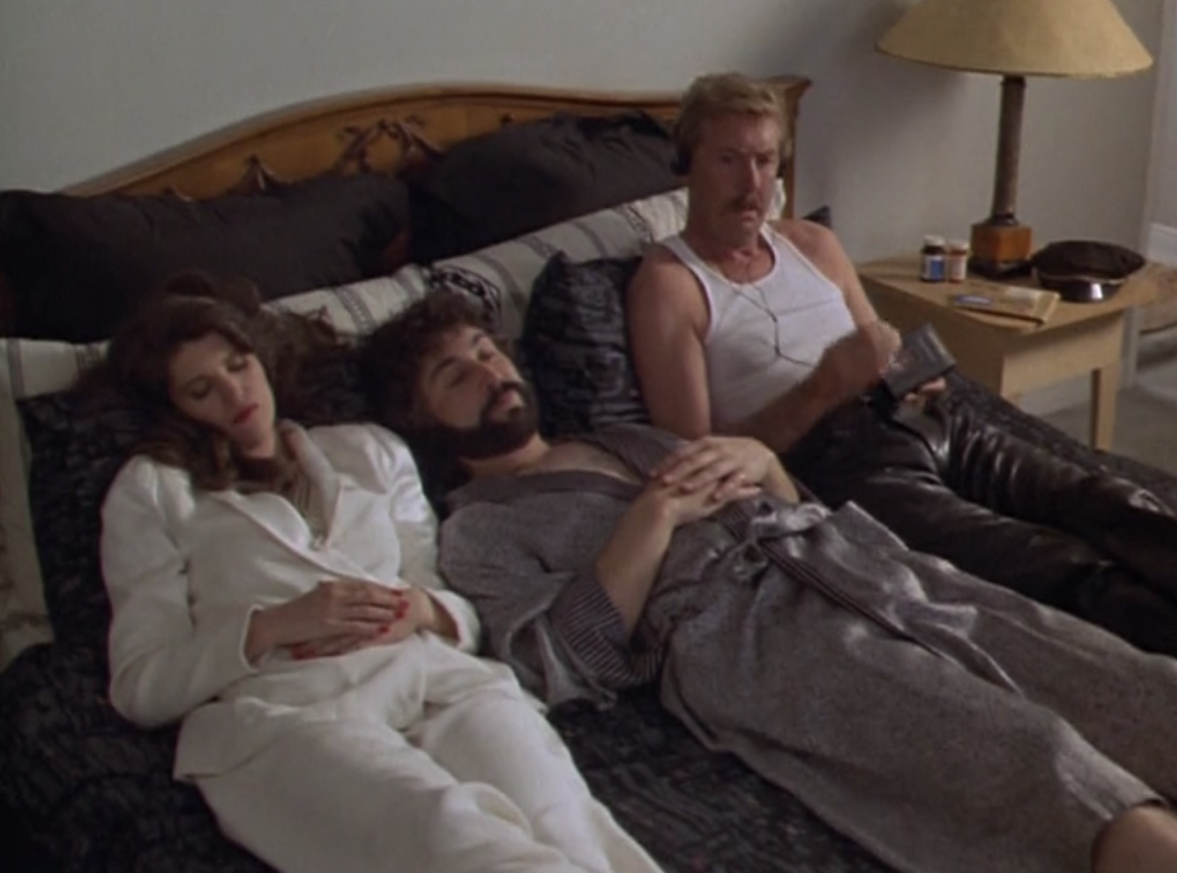 Susan, George and Sonny in bed, Sonny listening to the tape