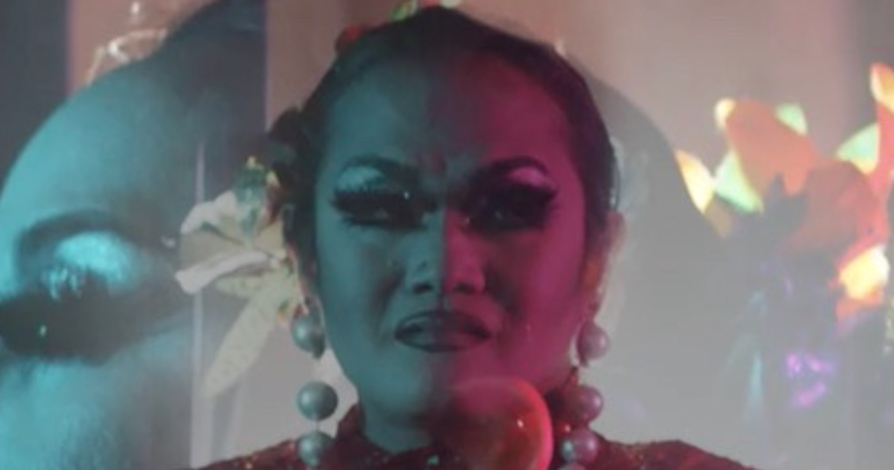 Aleksa Manila wears heavy makeup and is adorned with jewelry.
