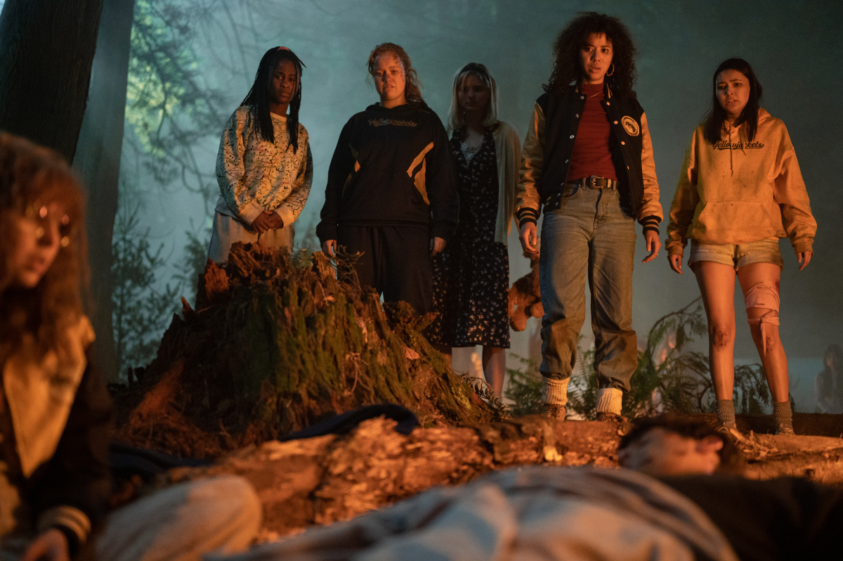 (L-R): Samantha Hanratty as Teen Misty, Keeya King as Teen Akilah, Liv Hewson as Teen Van, Jane Widdop as Teen Laura Lee, Jasmin Savoy Brown as Teen Taissa, Steven Krueger as Ben Scott and Alexa Barajas Plante as Teen Mari in YELLOWJACKETS, “F Sharp”.