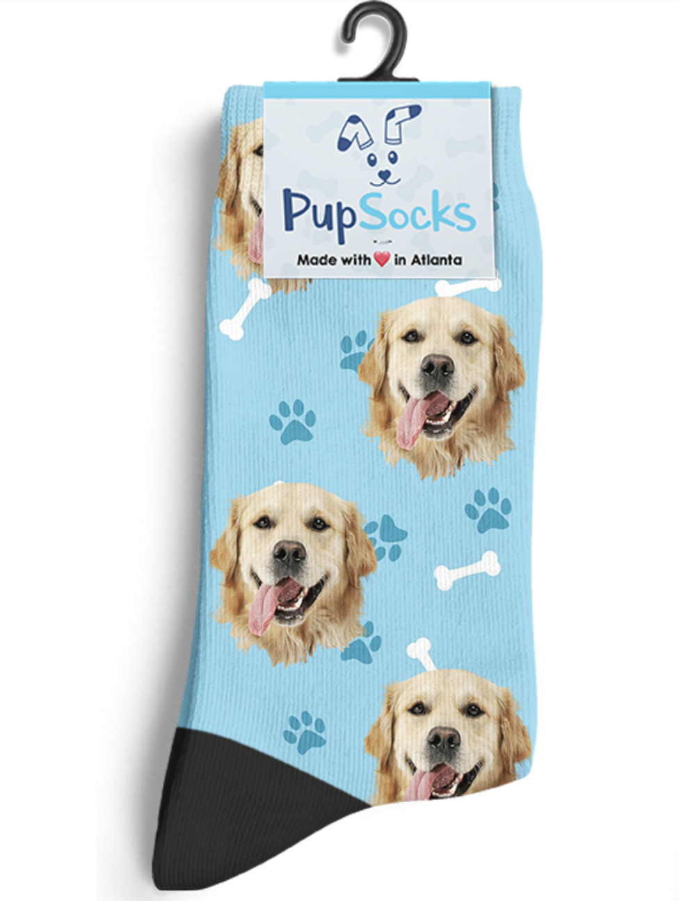 a light blue sock with various dog faces all over it