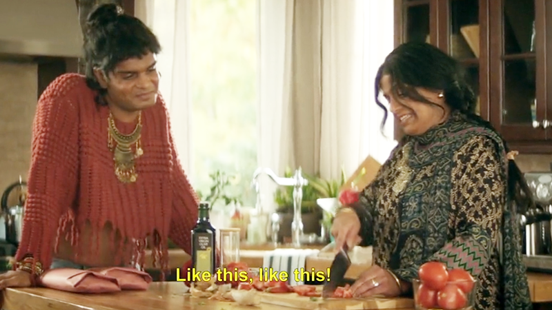 Sabi and Raffo in the kitchen together. The closed caption reads "Like this, like this!"