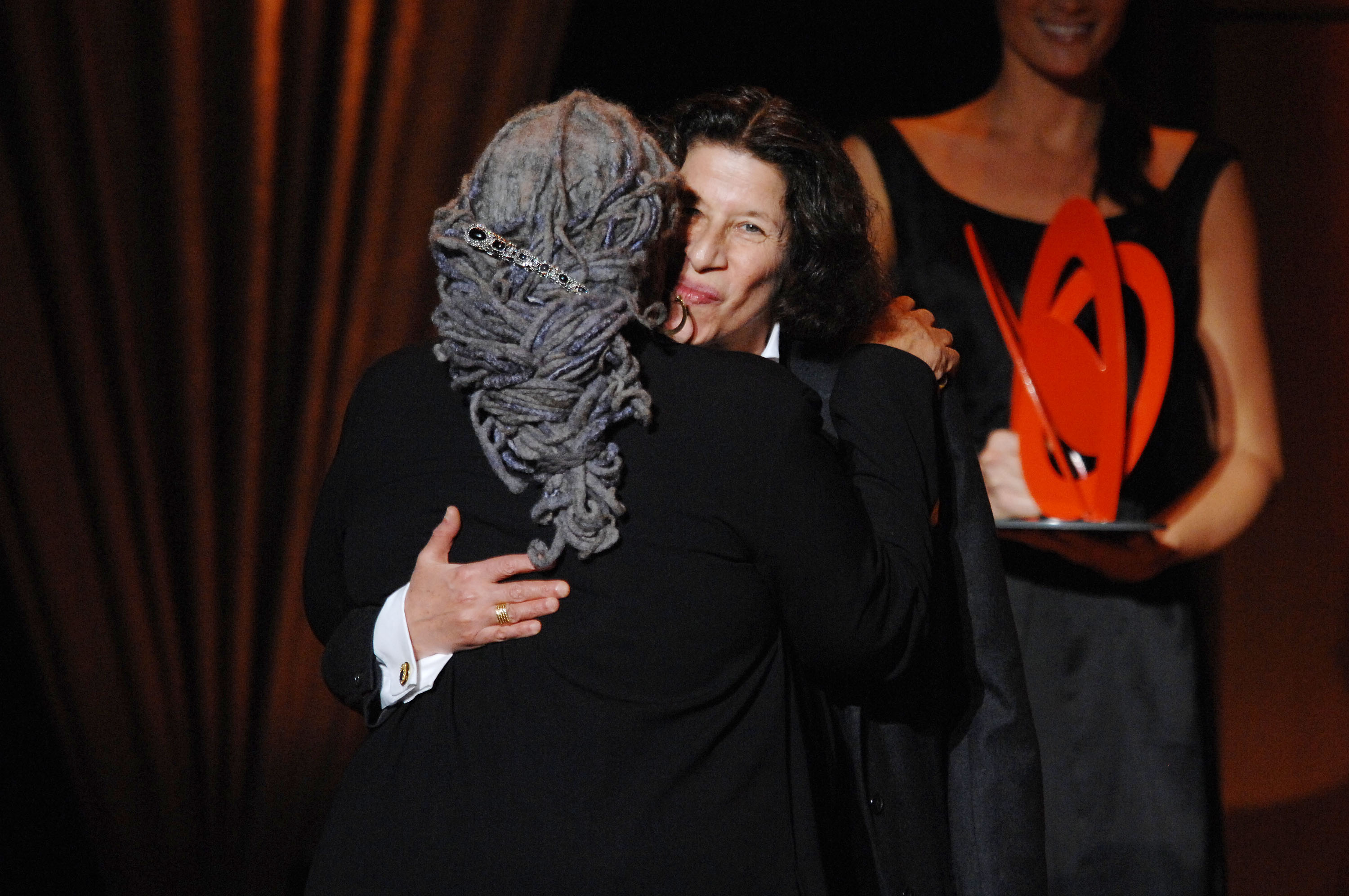 Toni Morrison (L) and Fran Lebowitz on stage during the Glamour Magazine 2007 Women of The Year Awards at Lincoln Center's Avery Fisher Hall on November 5, 2007 in New York City. They are hugging.