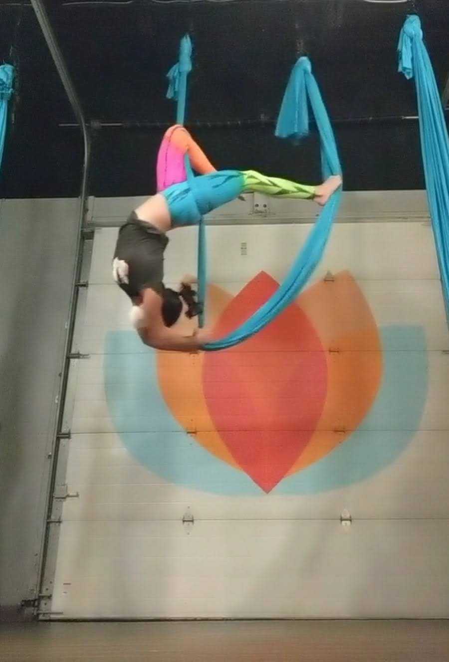 Here is Erin suspended in the air with those aerial yoga ribbins. She is upside down.