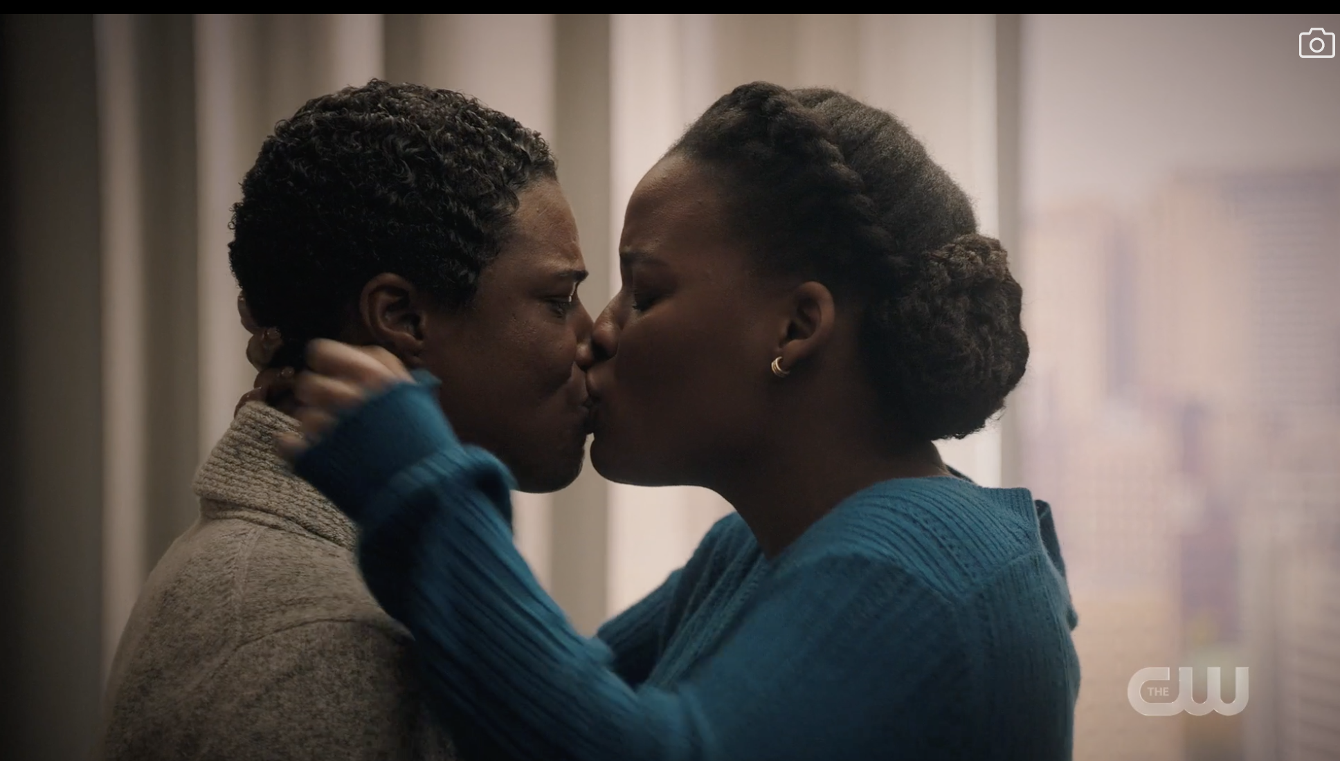 Shanice and Doc mid kiss while in a hotel room.