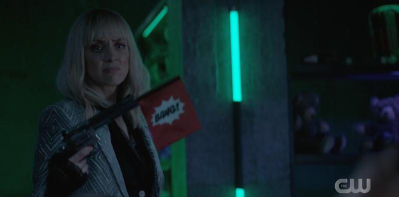 Alice standing holding the "bang" gun in disappointment