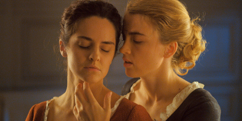 A photo of Heloise and Marianne in Portrait of a Lady on Fire embracing and touching erotically.