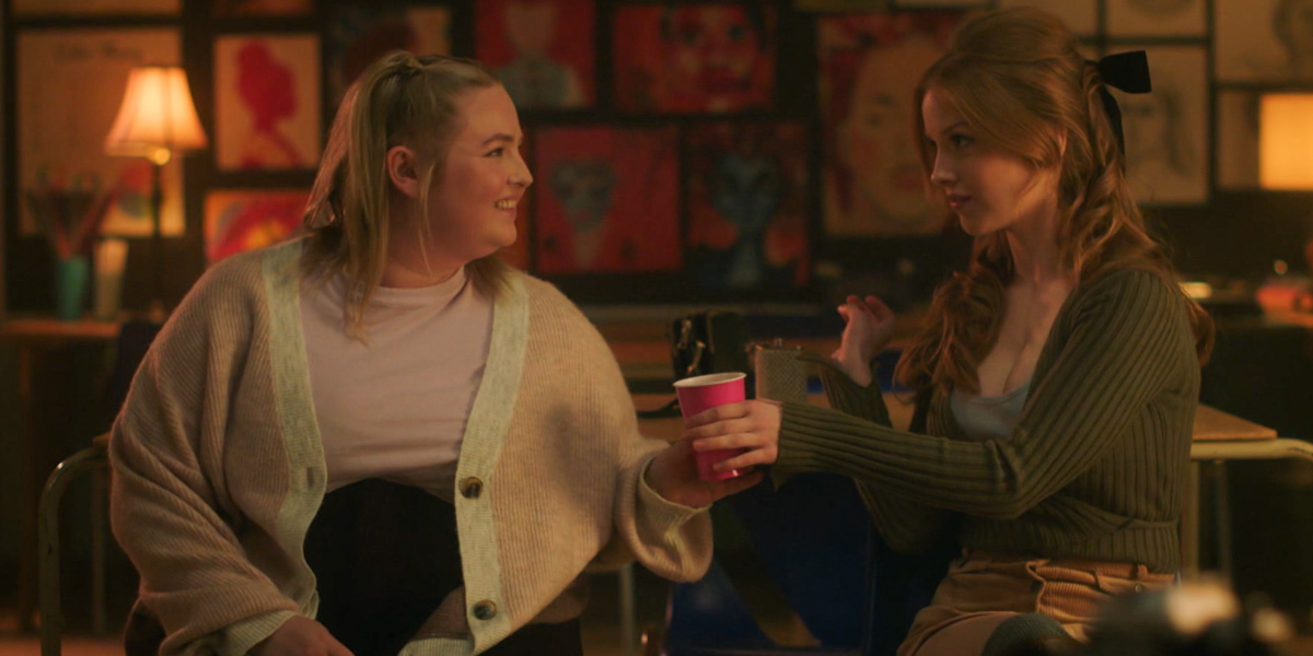 Candace hands Lilly a drink