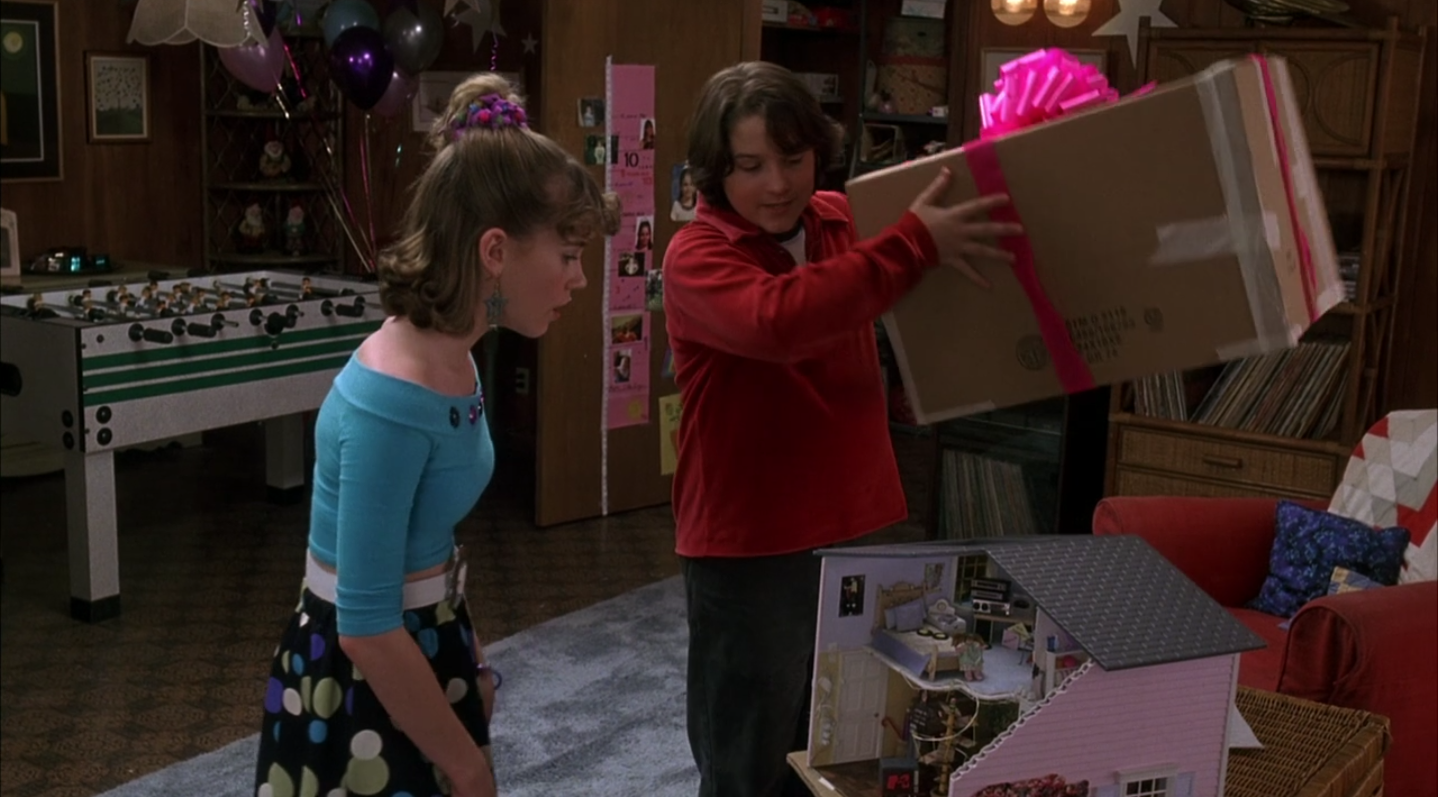 Young Matty unveils the Jenna Dream House, a toy house he got for young Jenna Rink, who looks at it in surprise