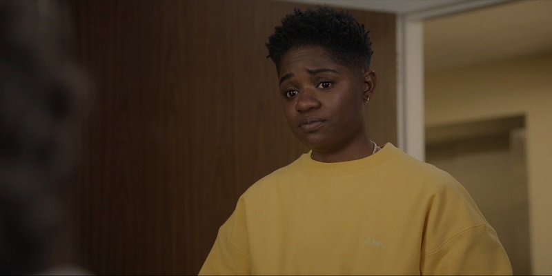 Wearing a mustard yellow sweatshirt, Coop shows up for her first cleaning job at the nursing home.