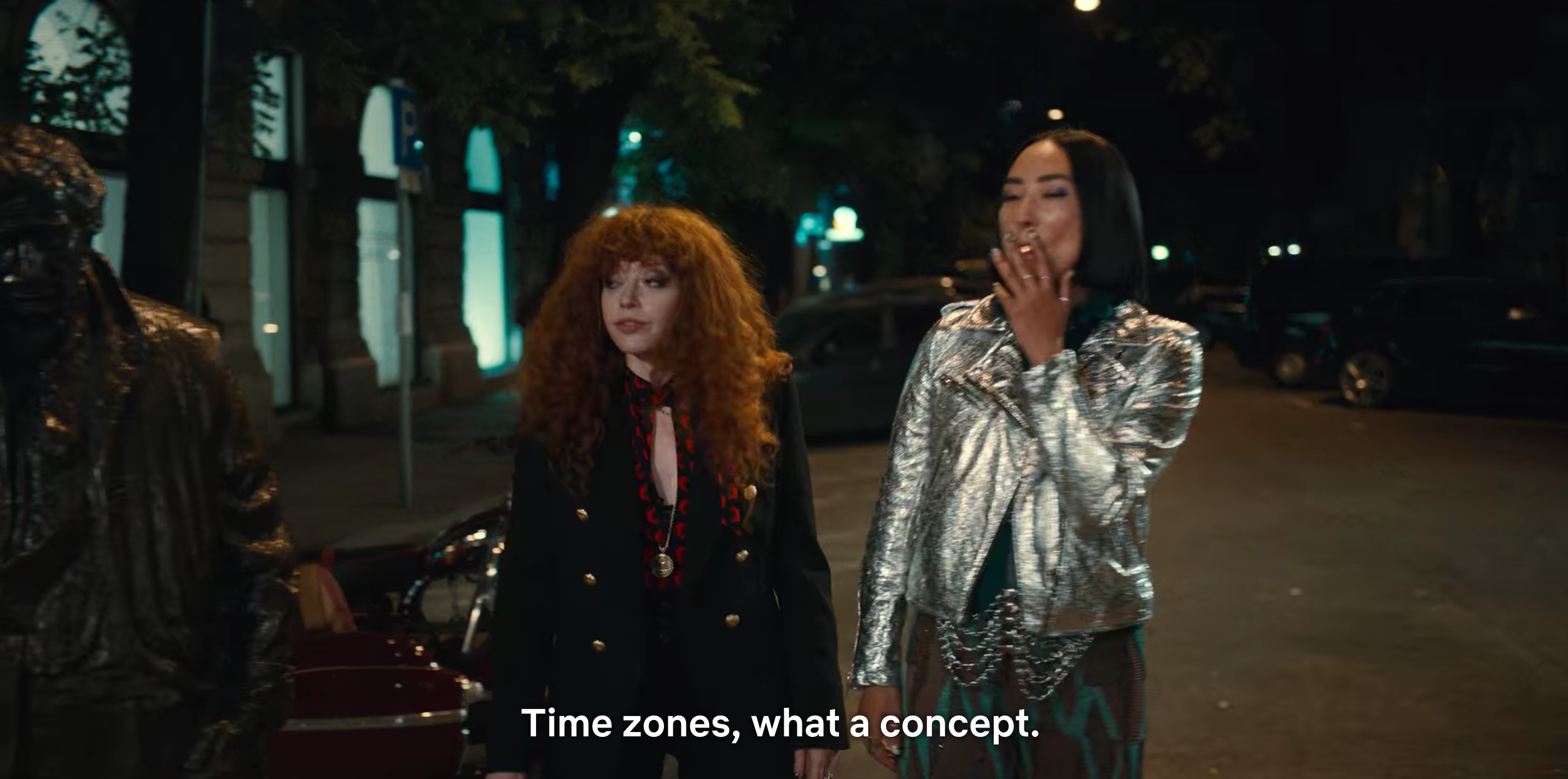 Natasha Lyonne as Nadia and Greta Lee as Maxine walk along a street in Budapest in Russian Doll season two. Nadia says: Time zones, what a concept?