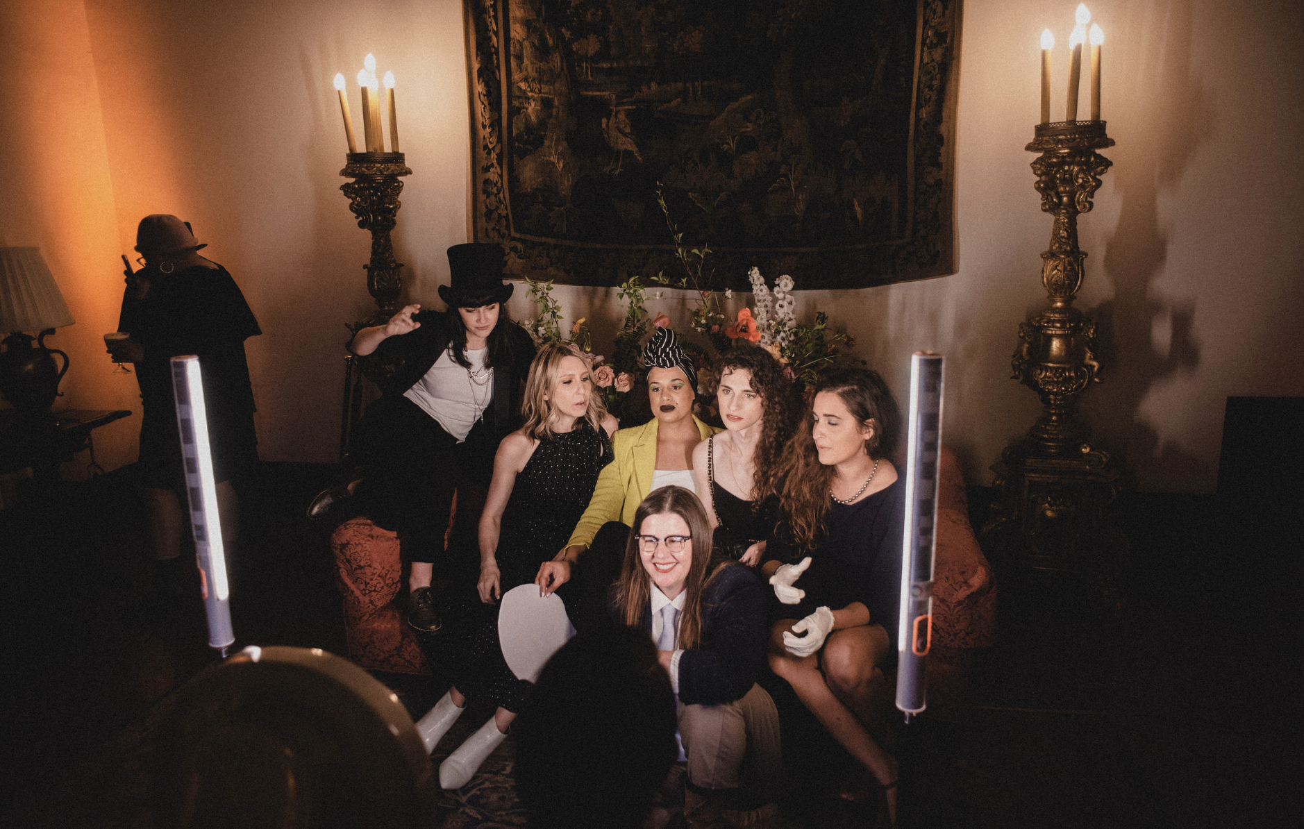 Autostraddle team and guests posing at an 1800s-style photobooth