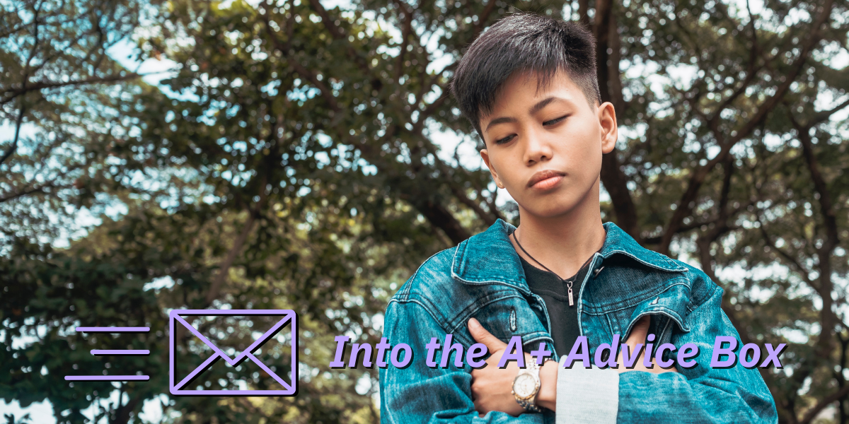 a young lesbian woman stands pensively in front of a bunch of trees. She has her arms folded and is wearing a jean jacket. Text on the image reads 