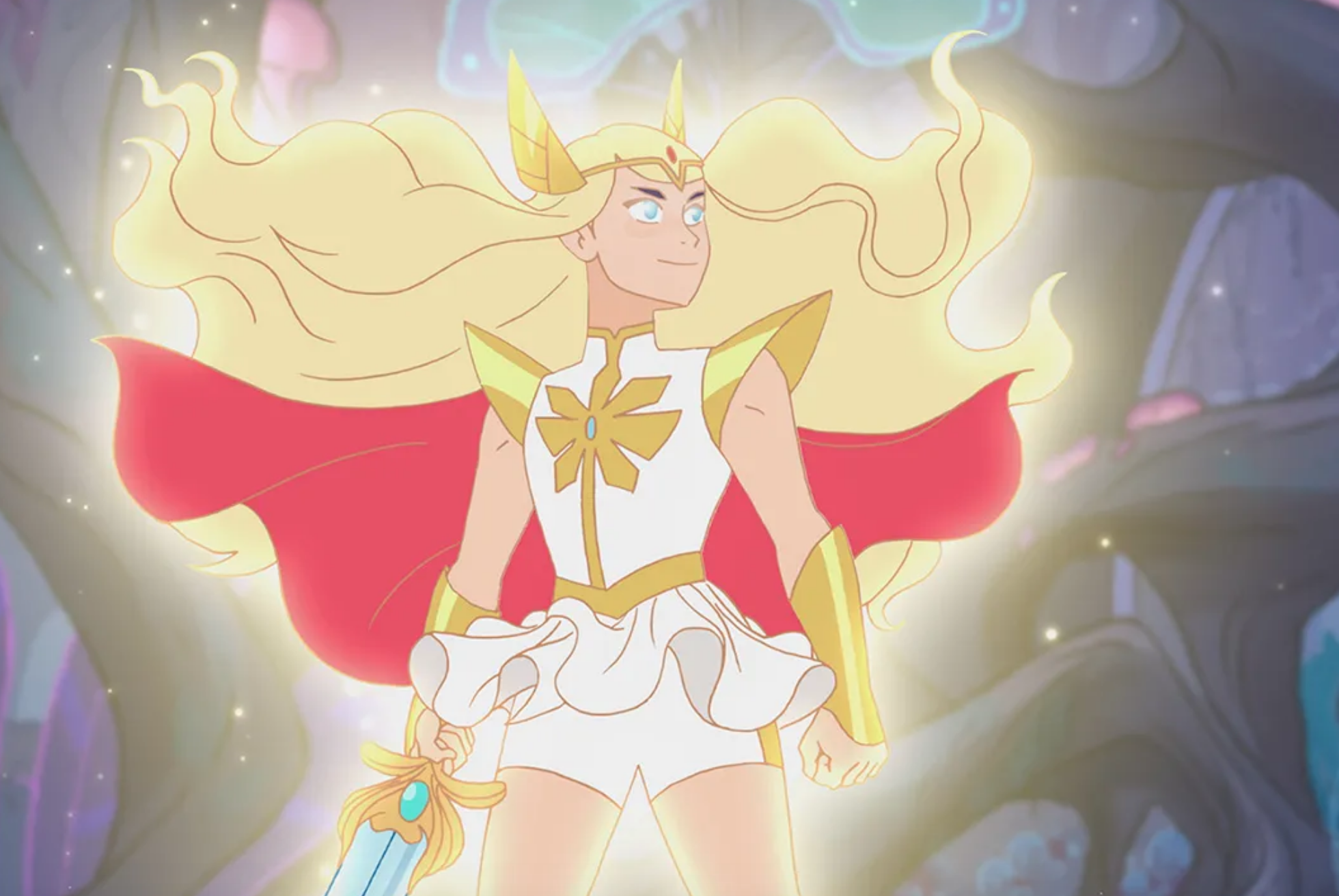 an animated woman, She-Ra, stands wearing a white and gold uniform and a red cape, holding a sword. her blonde hair flies behind her.