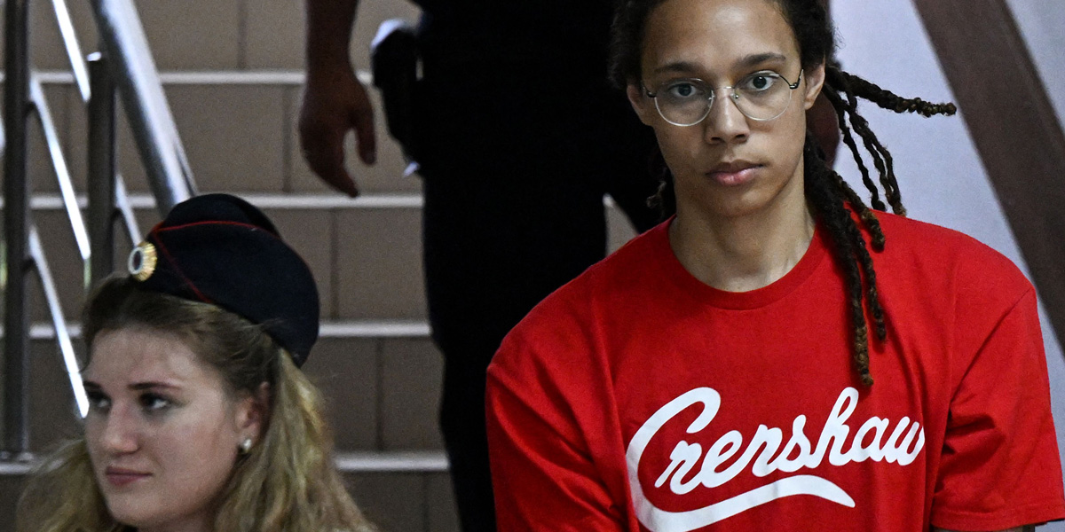 Brittney Griner is in a red t-shirt that says 