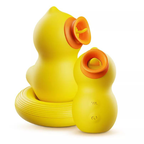Two yellow silicone sex toys shaped like the body of a duck are against a white background. One faces to the right and a smaller one faces to the front. The duck's "beaks" are open, orange circles. Inside each beak, there is a yellow "tongue."