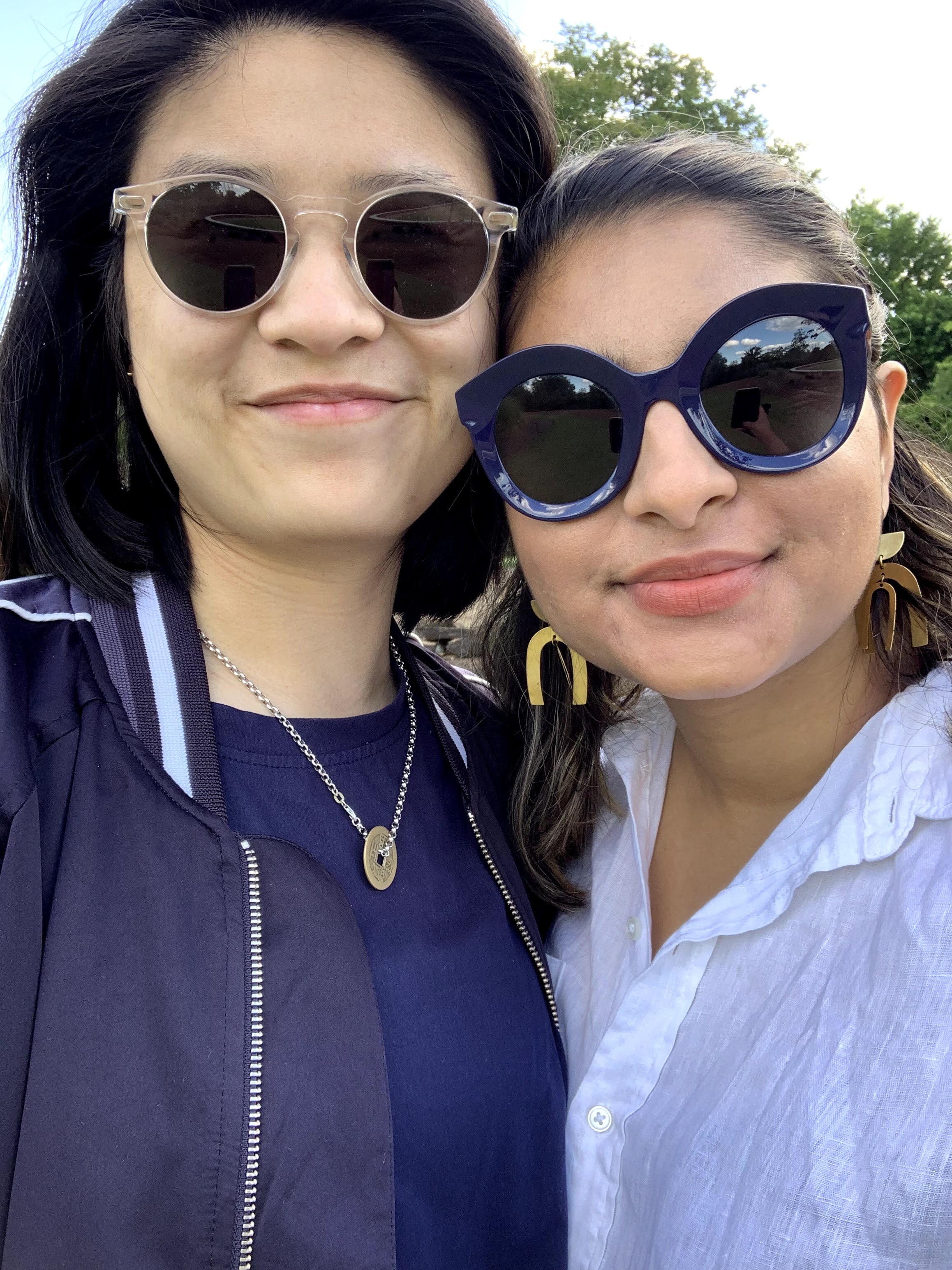 Ashni and Gerrie smile while wearing sunglasses