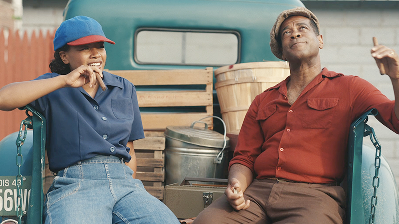 Max and her dad smoke cigars in the back of his truck. 