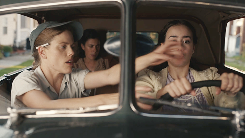 Jess helps Esti drive.